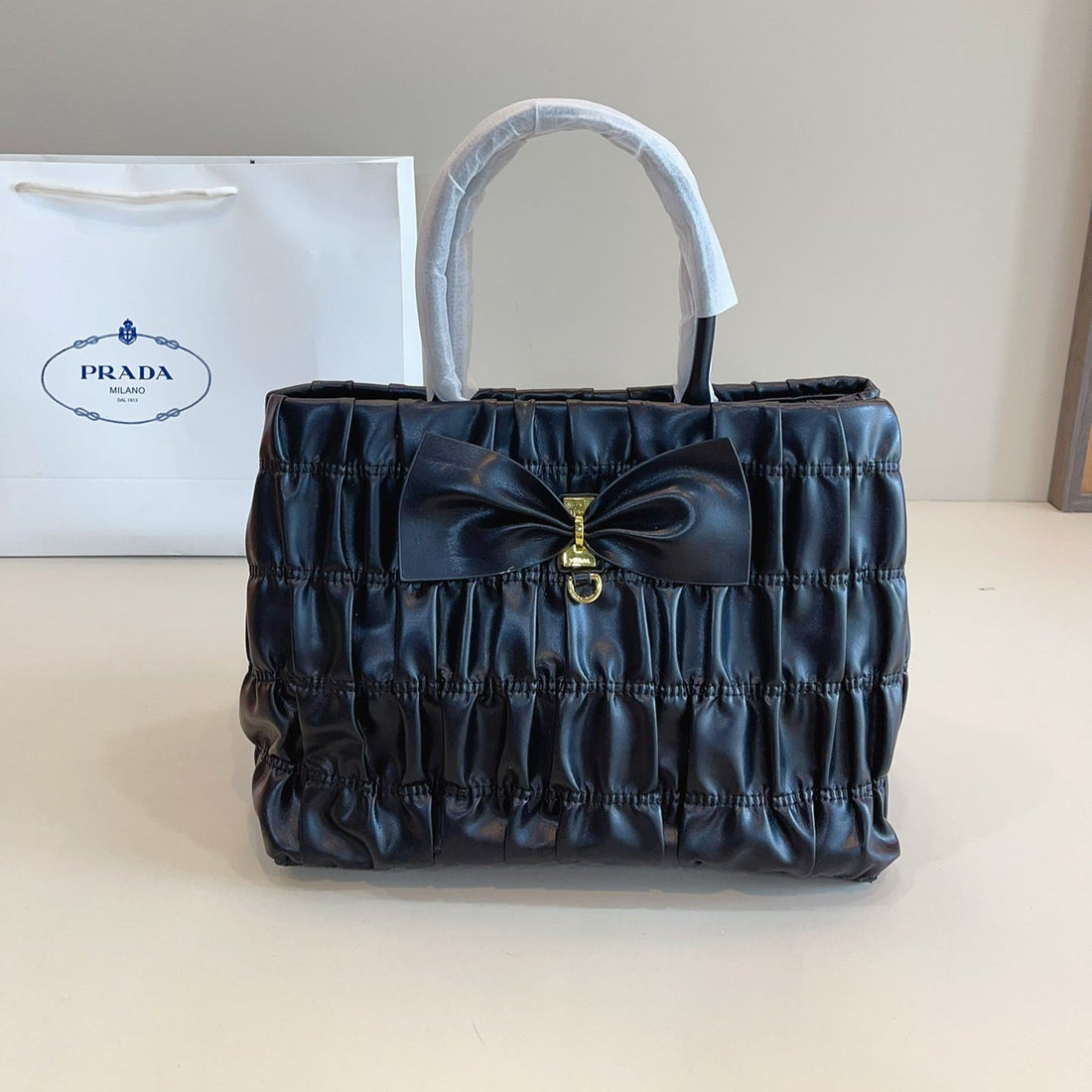 BOW DETAIL RUCHED TOP HANDLE BAG 29 IN BLACK SAFFIANO LEATHER