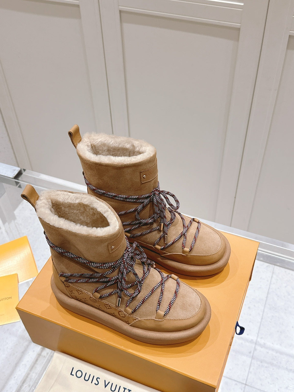 ASPEN PLATFORM ANKLE BOOT IN CIDER BROWN MONOGRAM DEBOSSED SUEDE AND SHEARLING