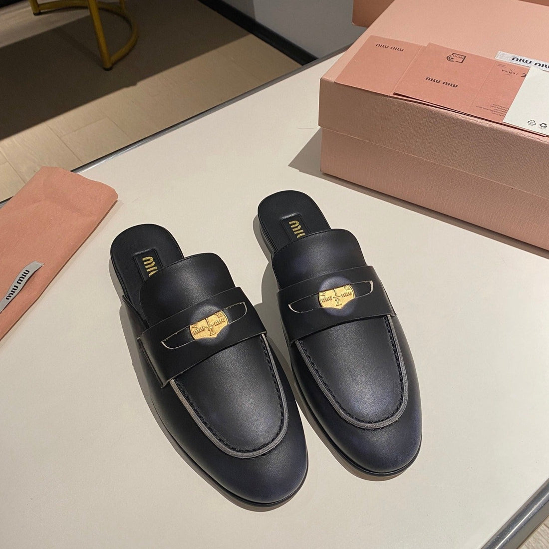 MULES SLIPPERS BLACK COWHIDE WITH GOLD COIN